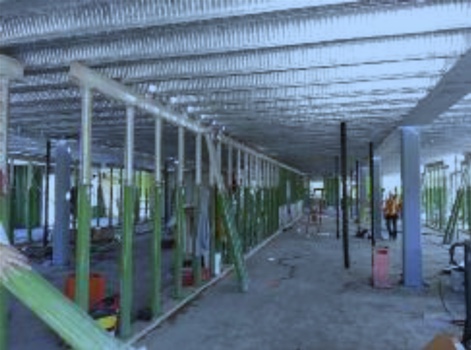 Contractors and steel beams of building under construction