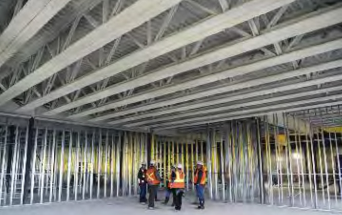 Workers amidst exposed steel beams