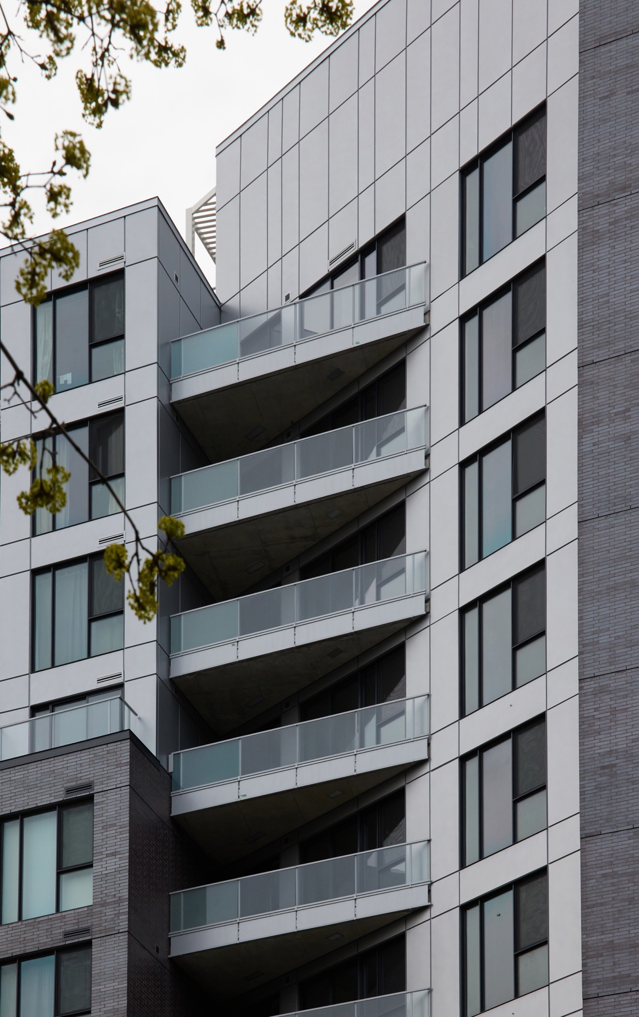 Grey brick and metal and glass balconies of August and Louis Condos, Montreal QC