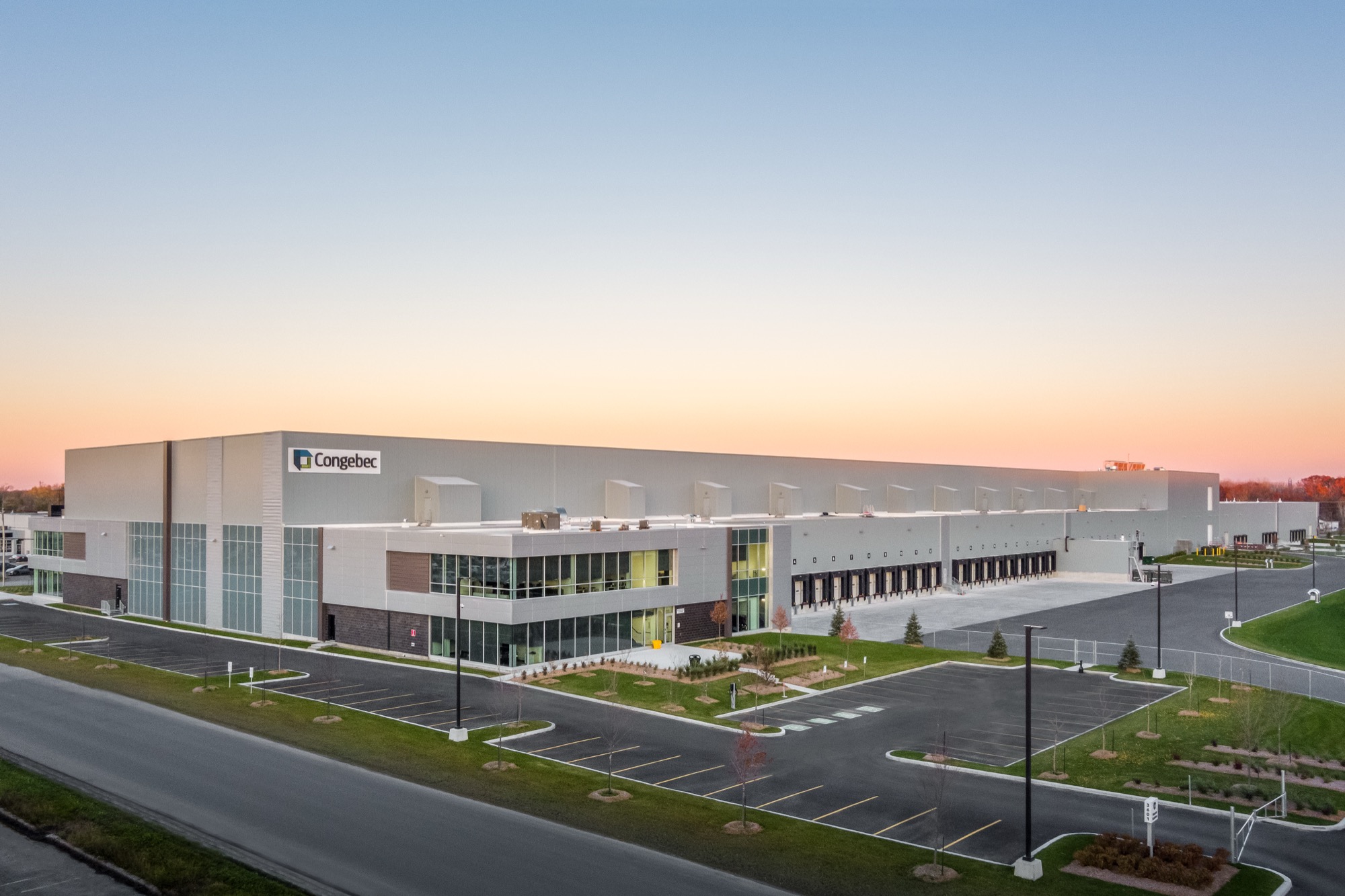 Full drone view of Congebec building exterior at dusk