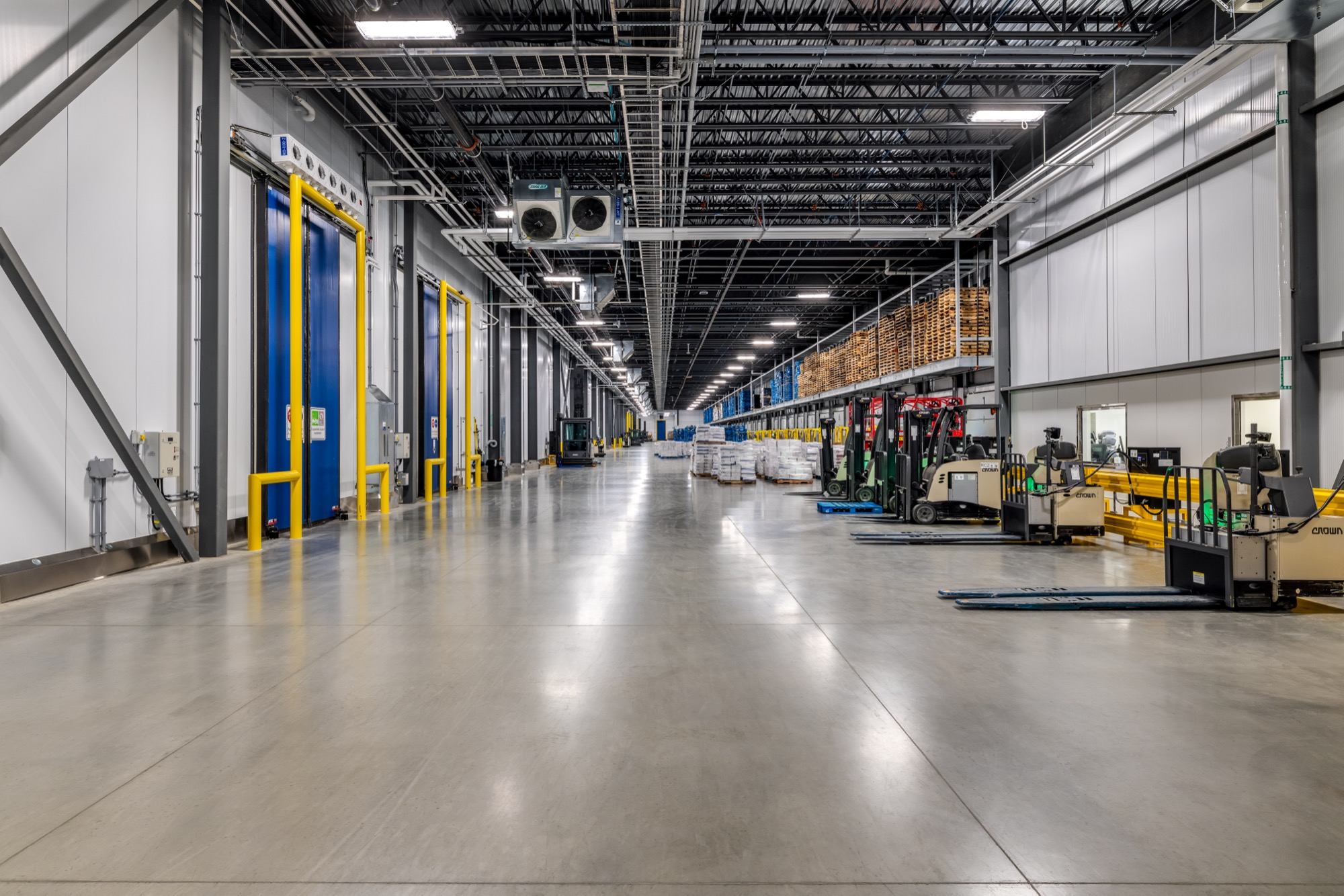Interior of Congebec facility, a hallway with forklifts along the side.