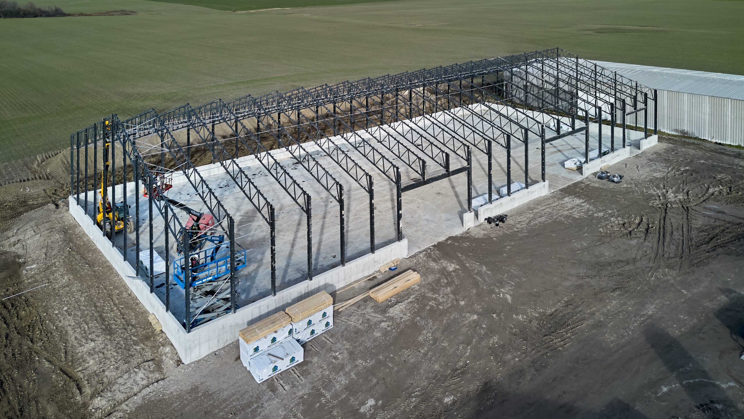 Aerial view of steel barn framing exposed while under construction