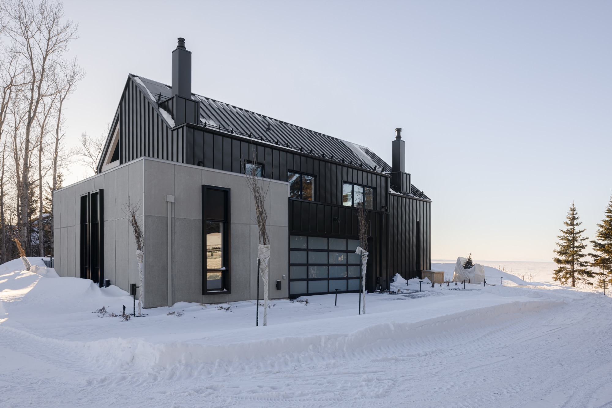 Exterior of residence showing view form back side of house with concrete add-on
